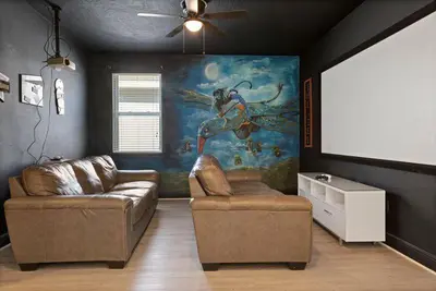 a living room with a couch and a painting on the wall at 551 Villa 8BD PoolSpa - Game room Movie room in Orlando