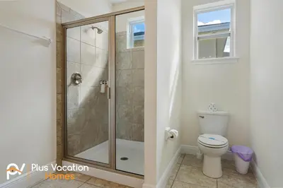 a bathroom with a shower and a toilet at 331 Villa SpaPool- GamesTheater by Disney in Orlando