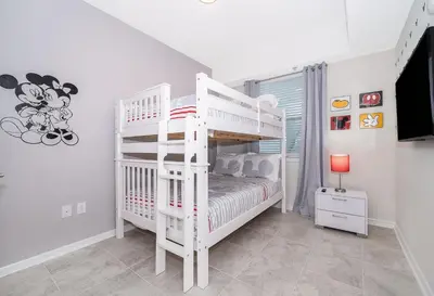 a white bunk bed in a white room at 3180-202BV STOREY LAKE, CONDO 2/2 GARDEN VIEW in Kissimmee