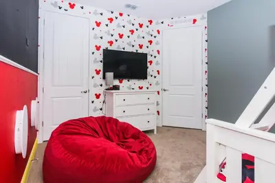 a red bean bag chair in a room with a television at Gorgeous Single Home with Private Pool at Encore in Orlando