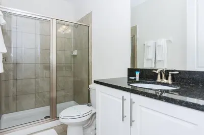 a bathroom with a shower and a toilet and a sink at Gorgeous Single Home with Private Pool at Encore in Orlando