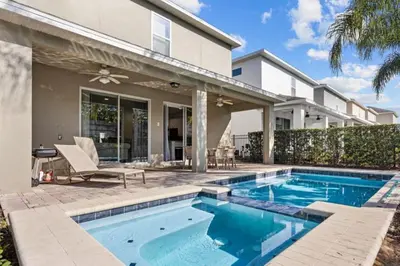 a swimming pool in front of a house at 320 Pet Friendly 6BD Villa - PoolSpa in Orlando