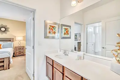 a bathroom with a sink and a mirror at Family Resort - 6BR Mansion - Private Pool, Home Theater, BBQ and More in Kissimmee