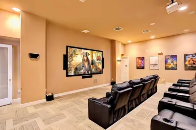 a waiting room with black chairs and a painting on the wall at Family Resort - 6BR Mansion - Private Pool, Home Theater, BBQ and More in Kissimmee