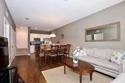 a living room with a couch and a table at Great and practical townhouse in gated community, sleeps 6 10 min to Disney! in Orlando