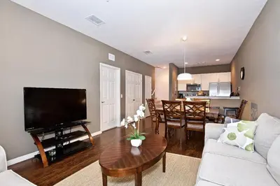a living room with a couch and a table at Great and practical townhouse in gated community, sleeps 6 10 min to Disney! in Orlando