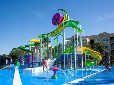 a pool with a water park with people playing in it at bsv_villa7747 in Orlando