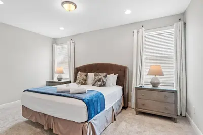 a bedroom with a bed and two night stands at Encore Resort 6 Bedroom Home with Pool 2301 in Orlando