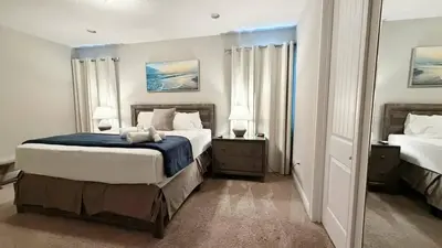 a large bedroom with two beds and two lamps at Encore Resort 6 Bedroom Home with Pool 2301 in Orlando