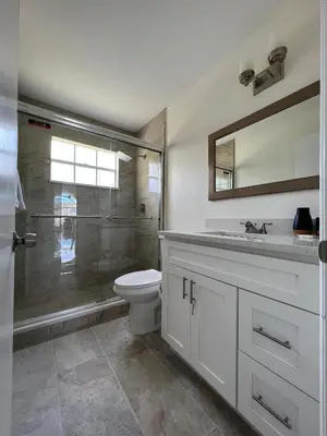 a bathroom with a shower and a toilet and a sink at ELEGANT & LUXURIOUS FAMILY APARTMENT close to DISNEY WORLD in Kissimmee