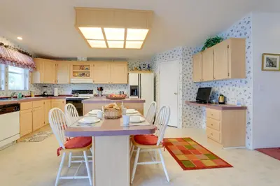 a kitchen with a table and chairs in it at Steps to Pool Winter Garden House with Lanai! in Orlando