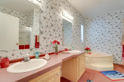 a bathroom with two sinks and a tub and a mirror at Steps to Pool Winter Garden House with Lanai! in Orlando