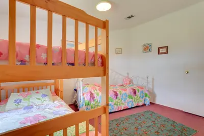 a bedroom with two bunk beds and a rug at Steps to Pool Winter Garden House with Lanai! in Orlando