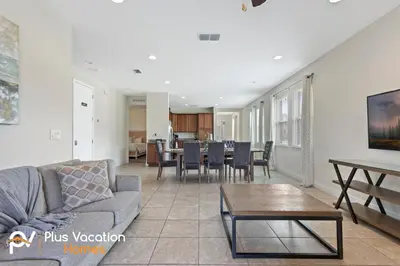 a living room with a couch and a table at 7541 Huge 8BD Home - POOLSpa - GameMovie room in Orlando