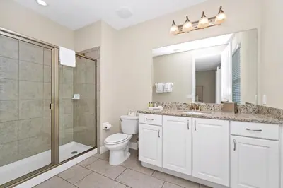 a bathroom with a toilet and a shower and a sink at Gleaming Home With Private Pool, Theater Room And Water Park Access Near Disney At Encore Resorts Reunion - 209Sf in Kissimmee
