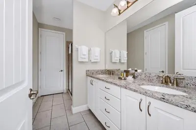 a bathroom with two sinks and a large mirror at Gleaming Home With Private Pool, Theater Room And Water Park Access Near Disney At Encore Resorts Reunion - 209Sf in Kissimmee