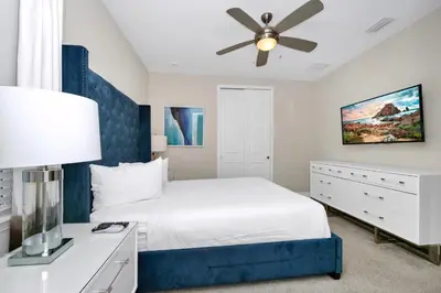 a bedroom with a bed and a ceiling fan at Gleaming Home With Private Pool, Theater Room And Water Park Access Near Disney At Encore Resorts Reunion - 209Sf in Kissimmee