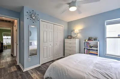 a bedroom with a white bed and blue walls at Apopka Single-Story Home with Private Lanai and Pool! in Orlando
