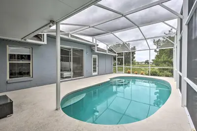 a swimming pool in a house with a glass ceiling at Apopka Single-Story Home with Private Lanai and Pool! in Orlando