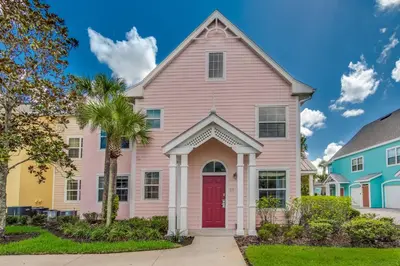 a pink house with a red door at 2 Bedroom Vacation Condo 2016 in Kissimmee