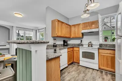 a kitchen with wooden cabinets and white appliances at 2 Bedroom Vacation Condo 2016 in Kissimmee