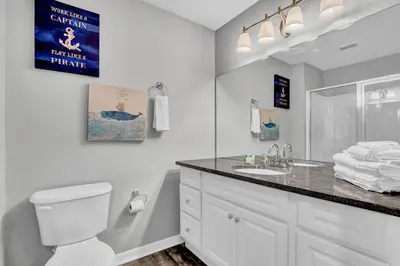 a bathroom with a white toilet and a sink at 2 Bedroom Vacation Condo 2016 in Kissimmee
