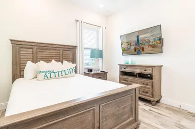 a bedroom with a large bed and a television at Relaxing Cottage Near Disney With Margaritaville Resort & Island H20 Waterpark Access - 2964Sr in Orlando