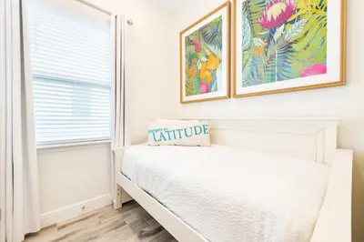 a white bedroom with a bed and a window at Relaxing Cottage Near Disney With Margaritaville Resort & Island H20 Waterpark Access - 2964Sr in Orlando
