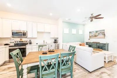 a kitchen and dining room with a table and chairs at Relaxing Cottage Near Disney With Margaritaville Resort & Island H20 Waterpark Access - 2964Sr in Orlando