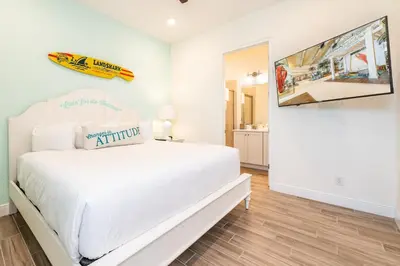 a white bedroom with a white bed and a tv at Happy Ours Cottage Near Disney With Private Hot Tub And Margaritaville Resort & Island H20 Waterpark Access - 3086Kl in Orlando
