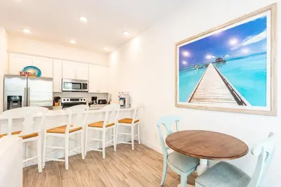 a kitchen and dining room with a table and chairs at Happy Ours Cottage Near Disney With Private Hot Tub And Margaritaville Resort & Island H20 Waterpark Access - 3086Kl in Orlando
