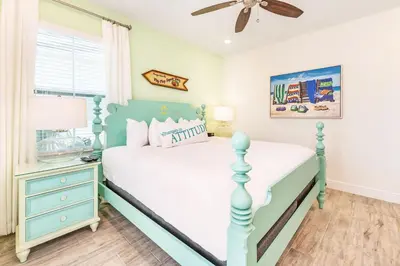 a bedroom with a blue and white bed and a window at Love, Luck And Magic Cottage With Private Hot Tub Near Disney And Margaritaville Resort & Island H2O Access - 8013Ff in Orlando