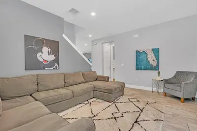 a living room with a couch and a chair at 650 Lasso Drive in Orlando