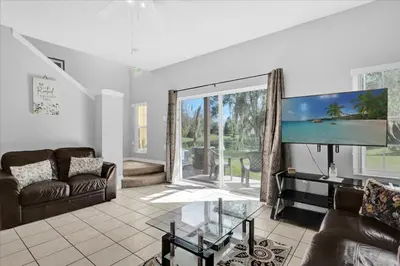 a living room with a tv and a couch at Spring retreat near Disney, Perfect for families in Kissimmee