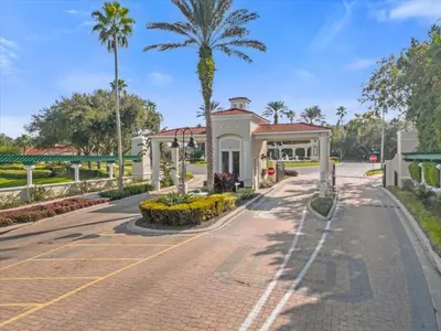 a house on a street with a palm tree at Spring retreat near Disney, Perfect for families in Kissimmee