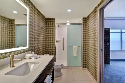 a bathroom with a sink and a toilet and a mirror at Home2 Suites By Hilton Orlando Flamingo Crossings, FL in Orlando