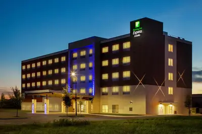 a hotel building with a sign on top of it at Holiday Inn Express & Suites Sanford - Lake Mary by IHG in Sanford