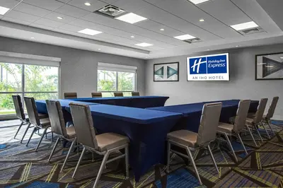 a conference room with a blue table and chairs at Holiday Inn Express & Suites Sanford - Lake Mary by IHG in Sanford
