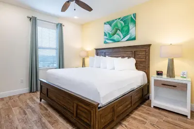 a bedroom with a large bed and a window at Lively Cottage Near Disney With Margaritaville Resort & Island H20 Waterpark Access - 2998Sr in Orlando