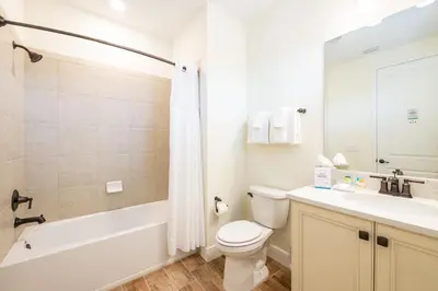 a bathroom with a toilet and a tub and a sink at Lively Cottage Near Disney With Margaritaville Resort & Island H20 Waterpark Access - 2998Sr in Orlando