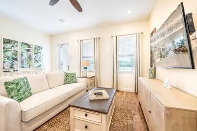 a living room with a couch and a table at Lively Cottage Near Disney With Margaritaville Resort & Island H20 Waterpark Access - 2998Sr in Orlando
