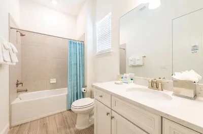 a white bathroom with a sink and a toilet and a tub at Don't Worry, Beach Happy Cottage Near Disney With Private Hot Tub & Margaritaville Resort & Island H20 Waterpark Access - 3005Sp in Orlando