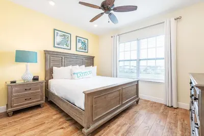 a bedroom with a bed and a ceiling fan at Toes In The Water Cottage With Private Pool Near Disney With Margaritaville Resort & Island H2O Access - 8008Sh in Orlando