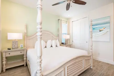 a bedroom with a white bed and a ceiling fan at Vivid Cottage Near Disney With Margaritaville Resort & Island H2O Access - 8024Ls in Orlando