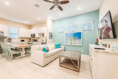 a living room with a couch and a table at Comfy Cottage With Hot Tub Near Disney With Margaritaville Resort & Island H2O Access - 8029Sb in Orlando