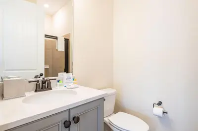 a bathroom with a sink and a toilet at Bright & Airy Cottage Near Disney With Margaritaville Resort & Island H2O Access - 8008Ls in Orlando
