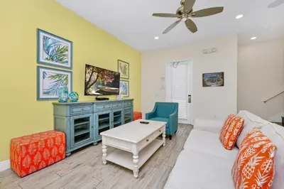 a living room with a couch and a table at Dreamy Cottage Near Disney With Margaritaville Resort & Island H2O Access - 8069Kd in Orlando