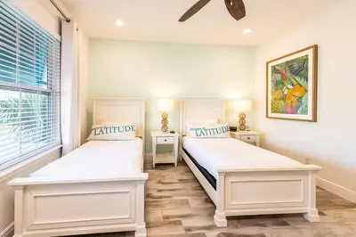 a bedroom with two beds and a window at Beautiful Cottage With Private Pool Near Disney With Margaritaville Resort & Island H20 Access - 8153Su in Orlando