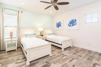 a bedroom with two beds and a ceiling fan at Beautiful Cottage With Private Pool Near Disney With Margaritaville Resort & Island H20 Access - 8153Su in Orlando