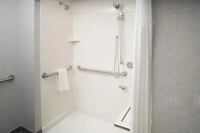 a bathroom with a shower with a shower curtain at Hampton Inn Kissimmee North in Kissimmee